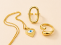 Set de joyas doradas en acero inoxidable con collar de ojo turco y anillos modernos ajustables